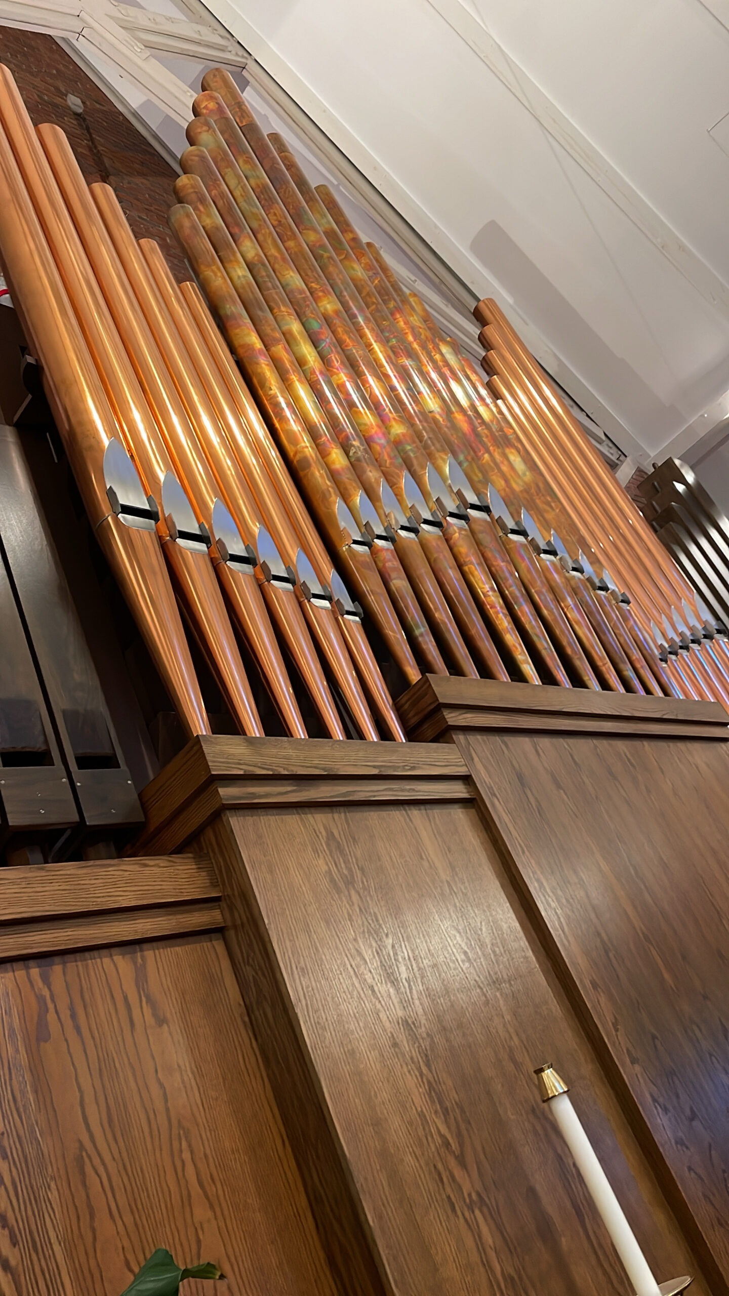 Close-up view of a pipe organ's copper pipes, showcasing intricate details and craftsmanship.